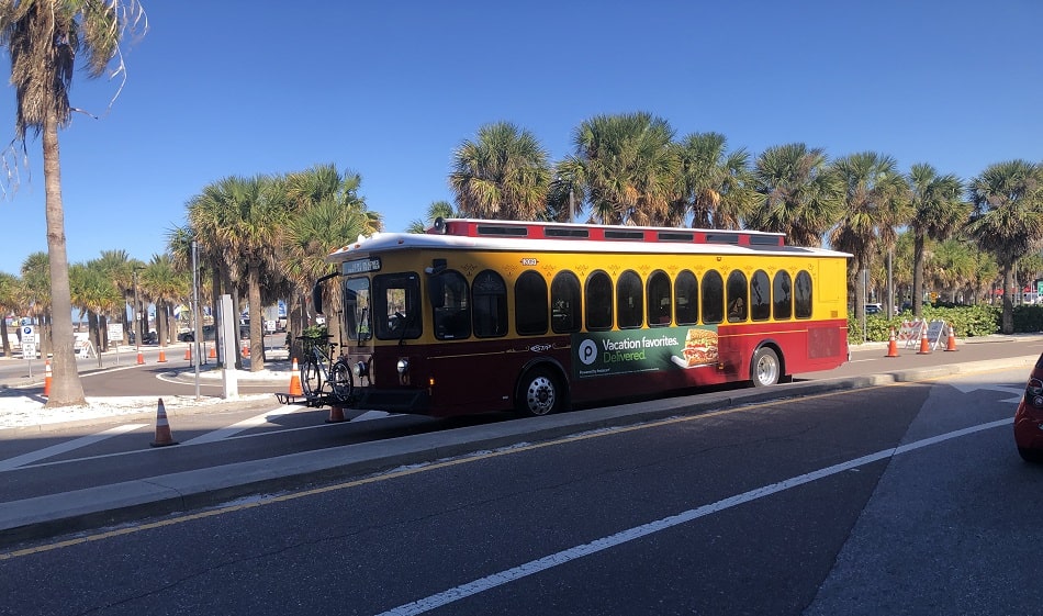 A private shuttle driving on a highway towards Clearwater Beach